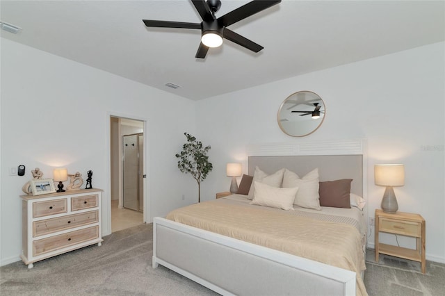 bedroom with light carpet, ceiling fan, visible vents, and baseboards