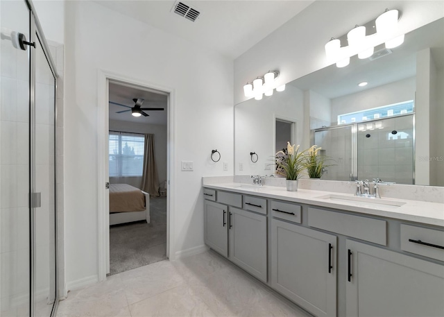 bathroom with a stall shower, plenty of natural light, and a sink