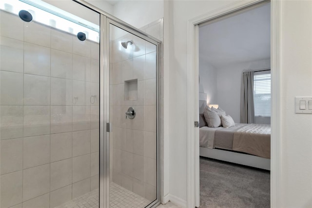 bathroom with a shower stall and connected bathroom