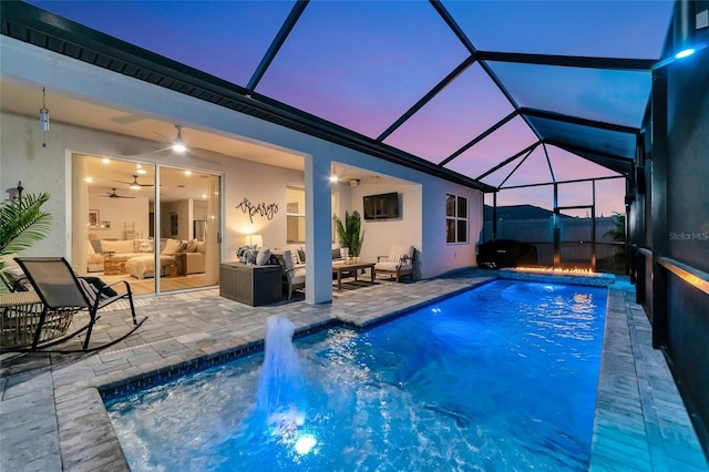 pool featuring a lanai, an outdoor living space, and a patio