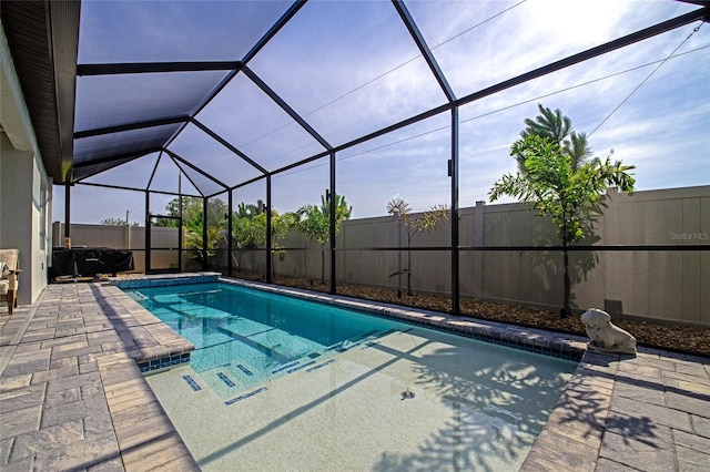 view of swimming pool featuring a patio, a fenced backyard, glass enclosure, and a fenced in pool