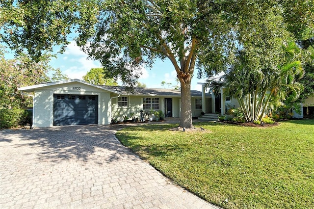 ranch-style home featuring a garage and a front lawn