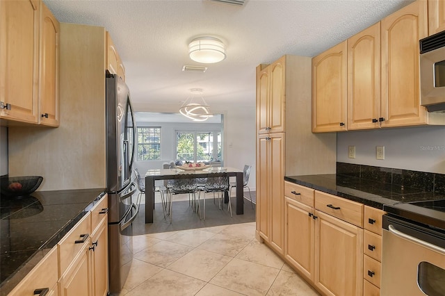 kitchen featuring light tile patterned floors, visible vents, tile countertops, stainless steel appliances, and light brown cabinetry