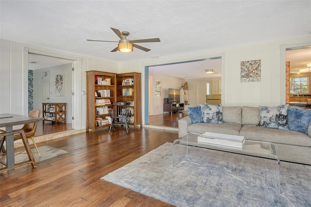 living room featuring dark hardwood / wood-style floors, sink, and ceiling fan