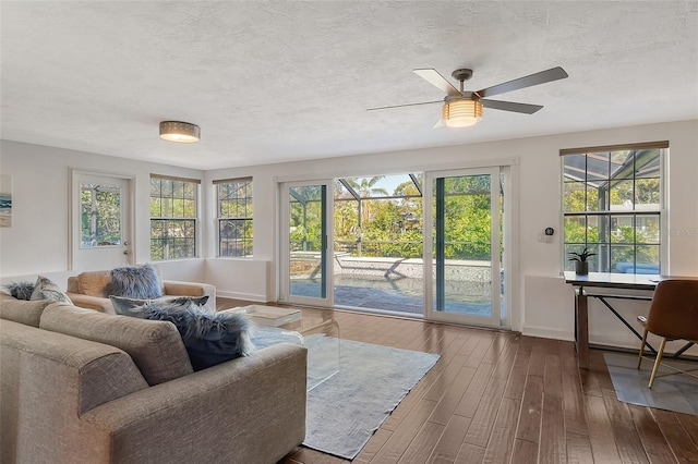 sunroom / solarium featuring a healthy amount of sunlight and ceiling fan