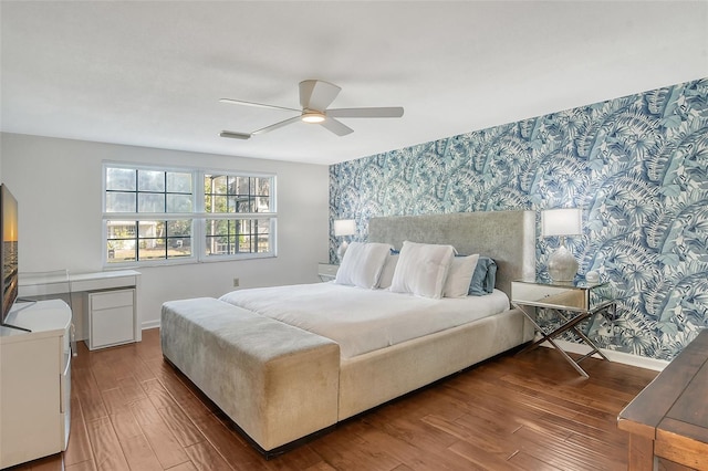 bedroom with ceiling fan and dark hardwood / wood-style floors