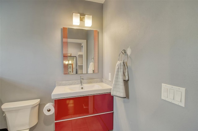 half bath with vanity and toilet