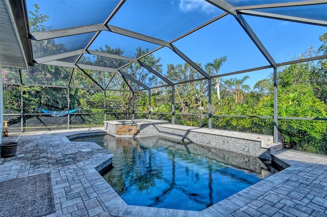 view of pool featuring a patio, a lanai, and a pool with connected hot tub