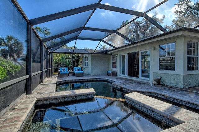 view of swimming pool featuring a lanai and a patio area