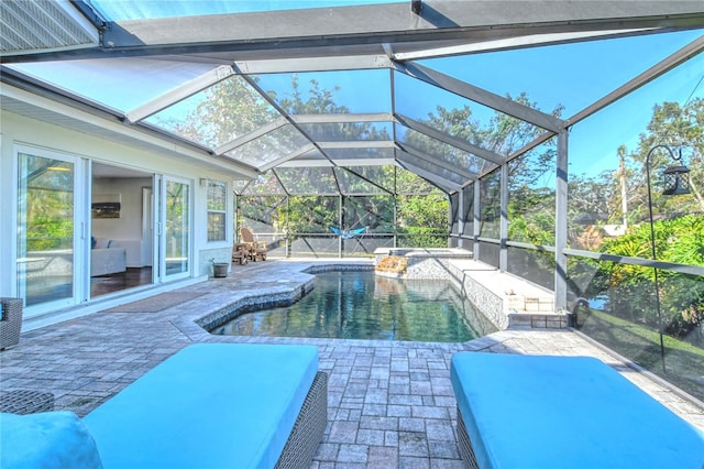 pool with a lanai and a patio area