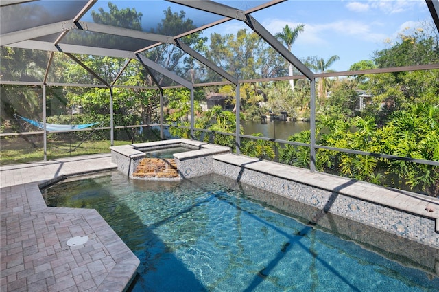 outdoor pool featuring a water view, glass enclosure, a patio area, and an in ground hot tub