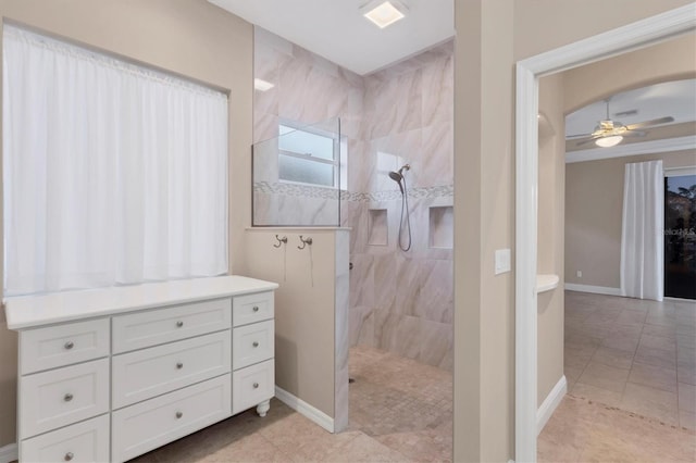 bathroom featuring tile patterned flooring, ceiling fan, and tiled shower