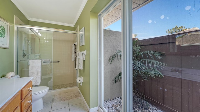 bathroom featuring a shower with door, vanity, ornamental molding, and toilet