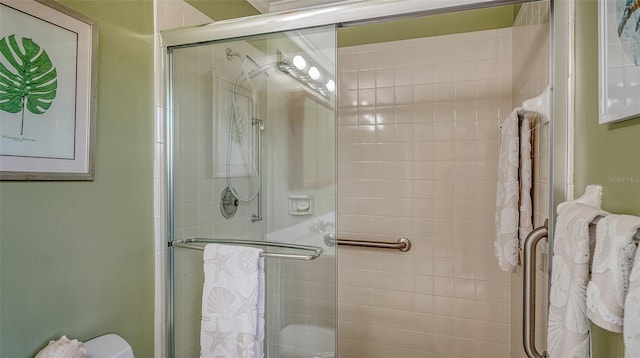 bathroom featuring a shower with door