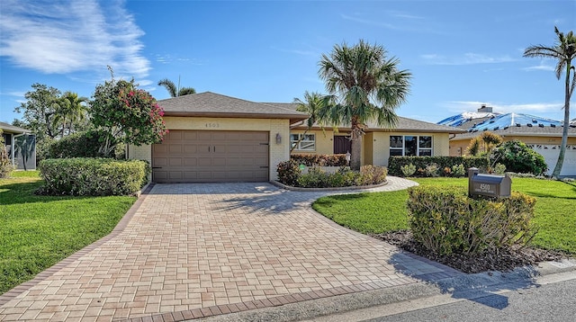 ranch-style home featuring a garage and a front yard