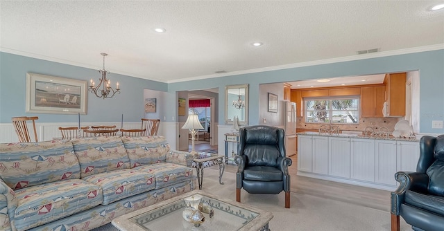 living room featuring crown molding, a textured ceiling, and a chandelier