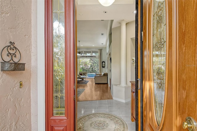 foyer with ornate columns and tile patterned flooring