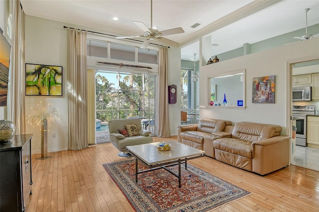 living room featuring light wood-type flooring and ceiling fan