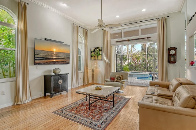 sitting room featuring crown molding, ceiling fan, and light wood-type flooring