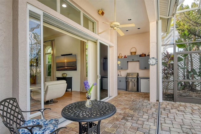 view of patio with exterior kitchen, sink, and ceiling fan