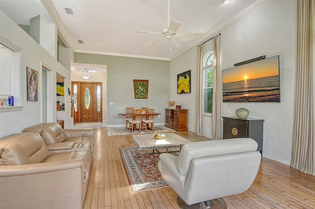 living room featuring crown molding, ceiling fan, and light hardwood / wood-style floors