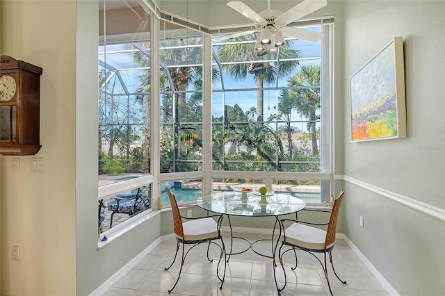 sunroom with a healthy amount of sunlight and ceiling fan