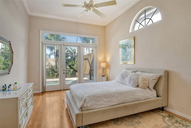 bedroom featuring ornamental molding, access to outside, ceiling fan, light hardwood / wood-style floors, and french doors