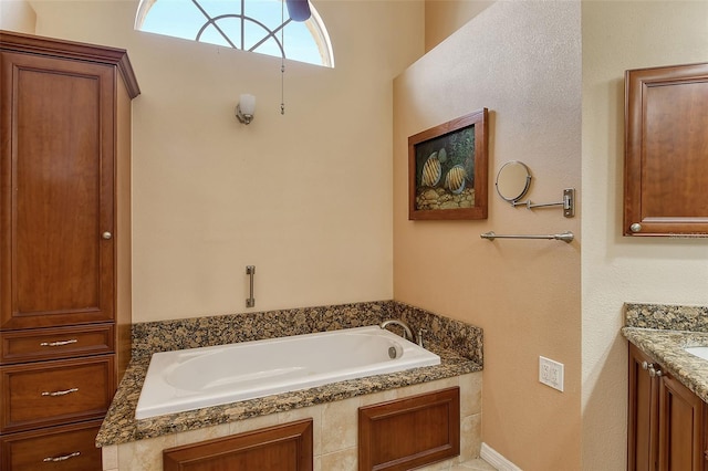 bathroom with vanity and a washtub