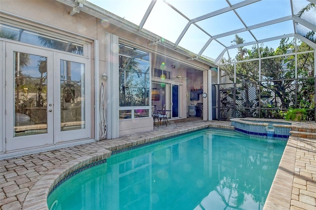 view of pool with french doors, an in ground hot tub, glass enclosure, and a patio