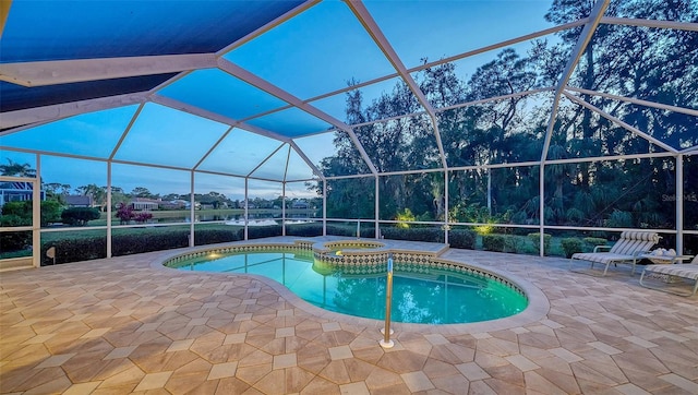 view of pool with a patio, an in ground hot tub, and glass enclosure