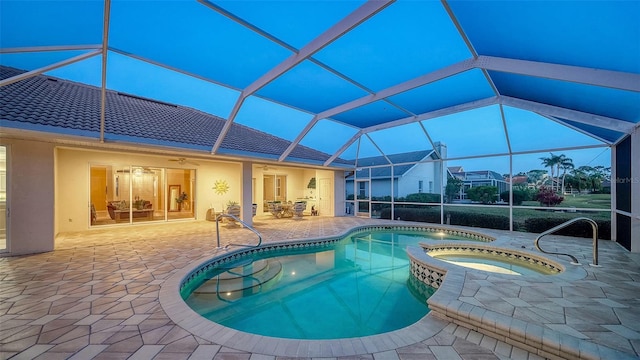 view of swimming pool with a patio area, an in ground hot tub, ceiling fan, and glass enclosure