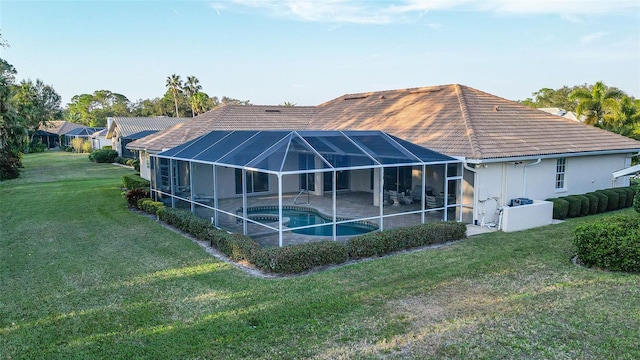 back of property featuring a yard, a lanai, and a patio area