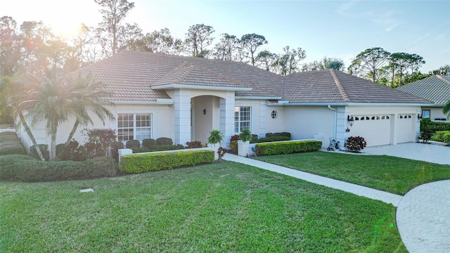 single story home with a garage and a front yard