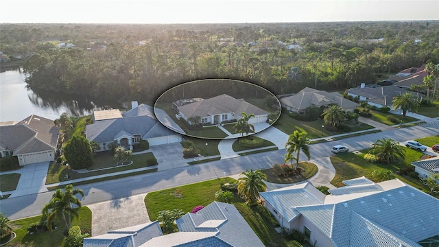 birds eye view of property with a water view