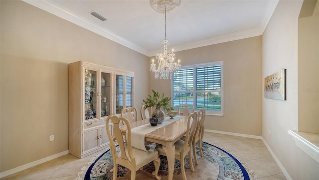 dining room featuring ornamental molding, light tile patterned floors, and an inviting chandelier