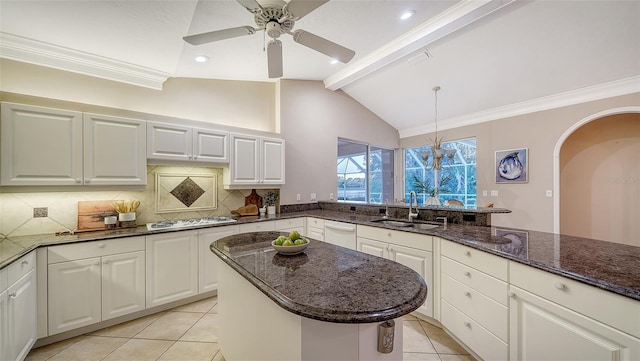 kitchen with pendant lighting, white cabinetry, sink, dark stone counters, and stainless steel gas cooktop