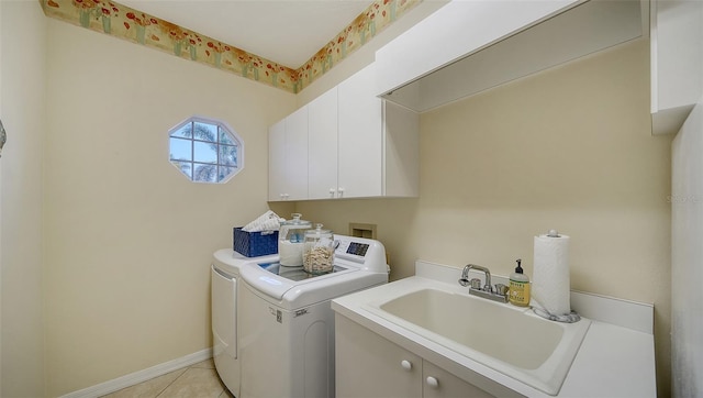 laundry room with cabinets, separate washer and dryer, sink, and light tile patterned floors