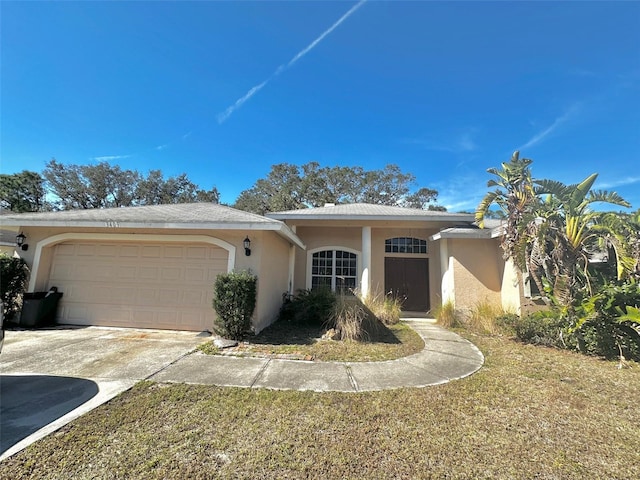 view of front of home with a garage and a front yard