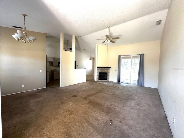 unfurnished living room featuring lofted ceiling, ceiling fan with notable chandelier, a textured ceiling, and washing machine and clothes dryer