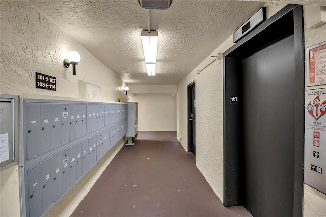 hall featuring a mail area and elevator