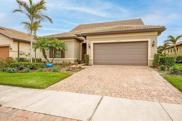 mediterranean / spanish-style house with a garage