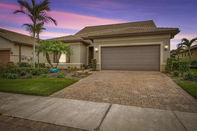 mediterranean / spanish-style home with a garage