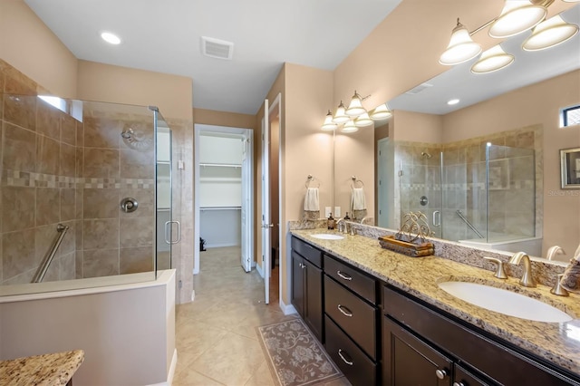 bathroom with vanity, an enclosed shower, and tile patterned floors