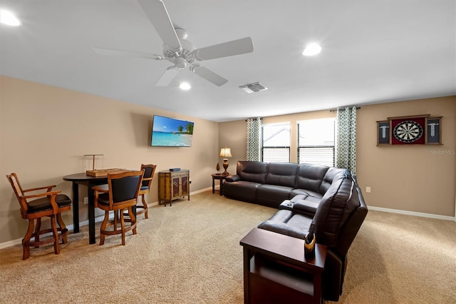 living room featuring light carpet and ceiling fan