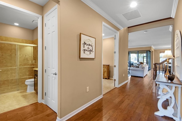 hall with ornamental molding and dark hardwood / wood-style flooring