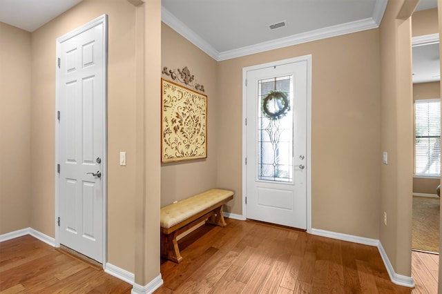 foyer with crown molding and light hardwood / wood-style flooring