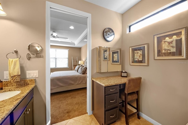 bathroom featuring tile patterned flooring, vanity, ornamental molding, ceiling fan, and a raised ceiling