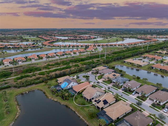 aerial view at dusk with a water view