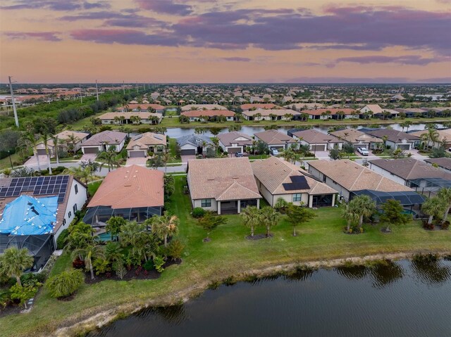 aerial view at dusk with a water view