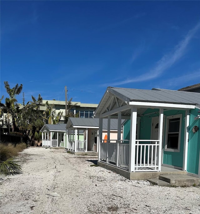 rear view of property with covered porch